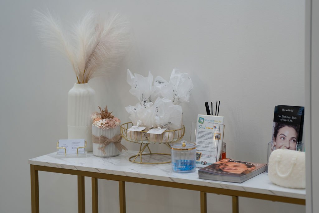 Eternity clinic details — pampas grass, business cards and curated reception display